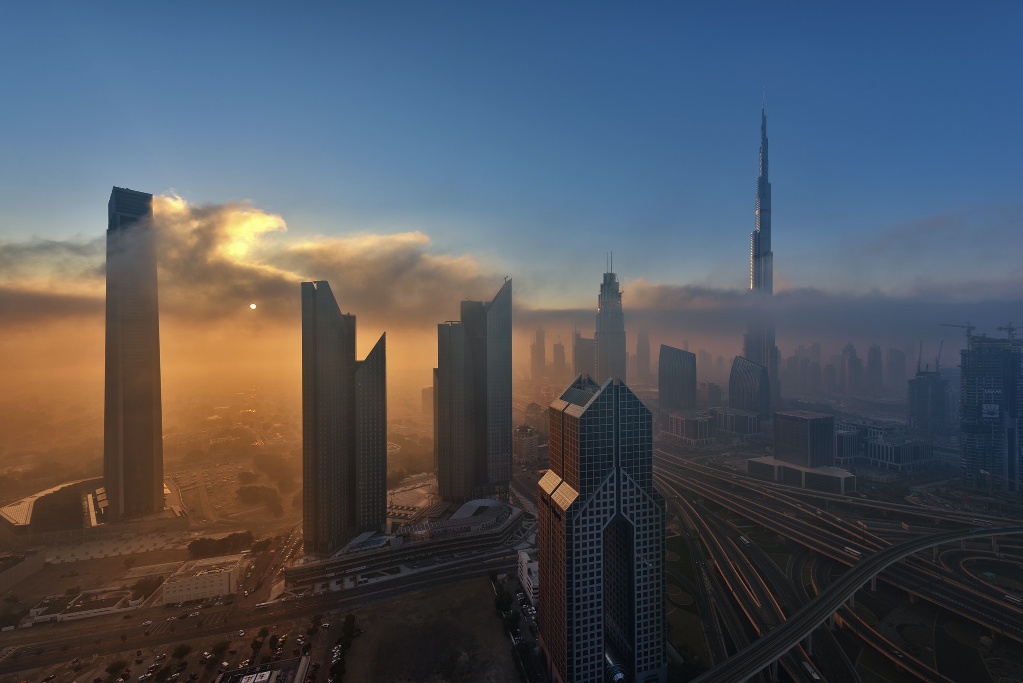 Citiscape with skyscrapers in Dubai, United Arab Emirates at dusk.